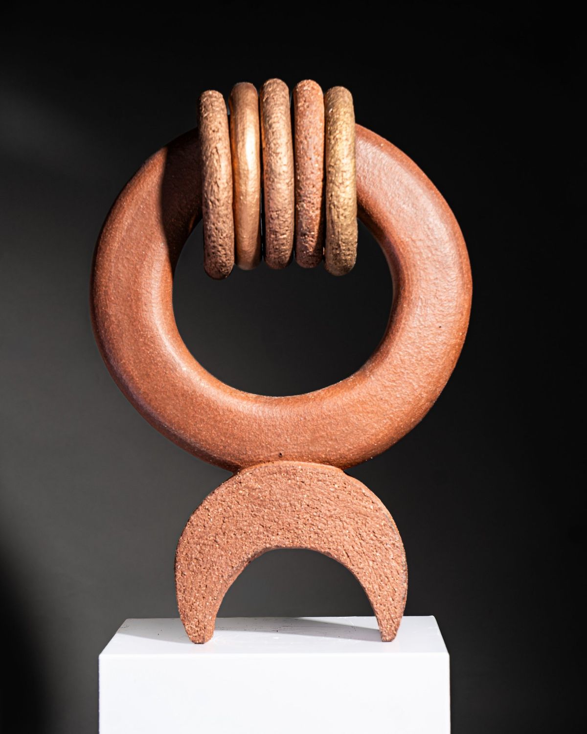 Terracotta ring with five stacked rings above a crescent base